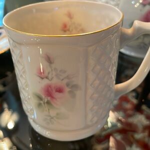 Matching cups ivory with rose design. You are purchasing 2 for the$28.